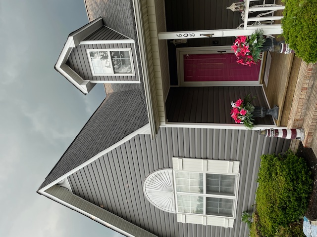 After: new architectural shingle roof and crisp white trim on the finished home