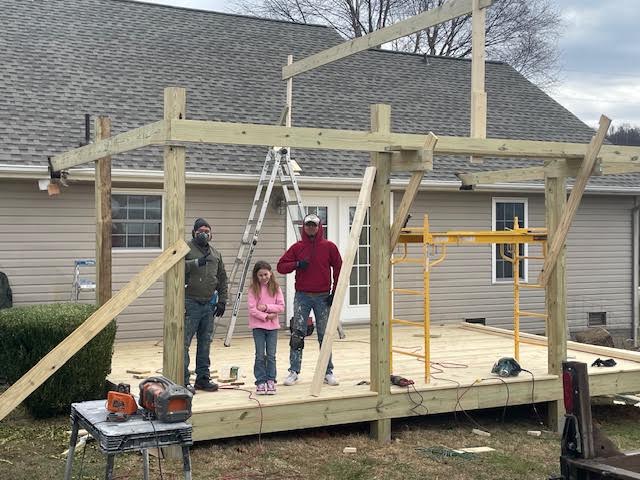 Before: new porch framing and posts going up over a fresh deck